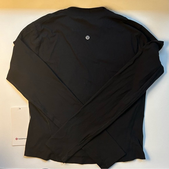 New with tags. Lululemon. Glass trim run 1/2 zip. Black. Size 10 - Picture 2 of 4